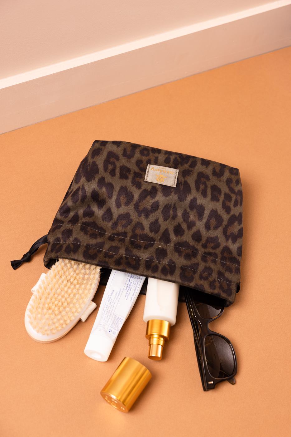 Leopard print pouch with beauty products